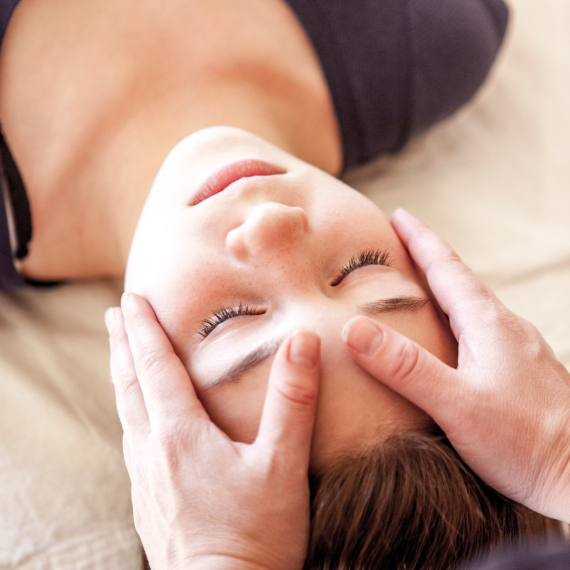Hands on clients head, giving healing