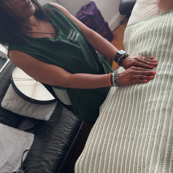 A client laying on the therapy couch/bed whilst receiving Energy healing in London by Dahni a Reiki practitioner